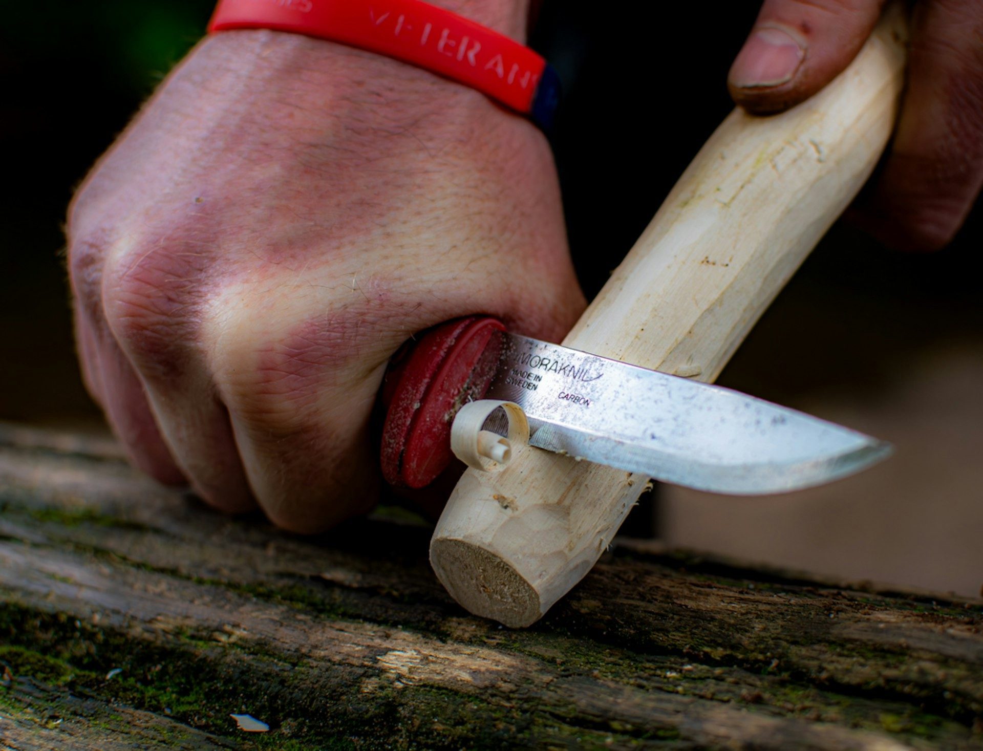 Bushcraft knife carving a wooden stick