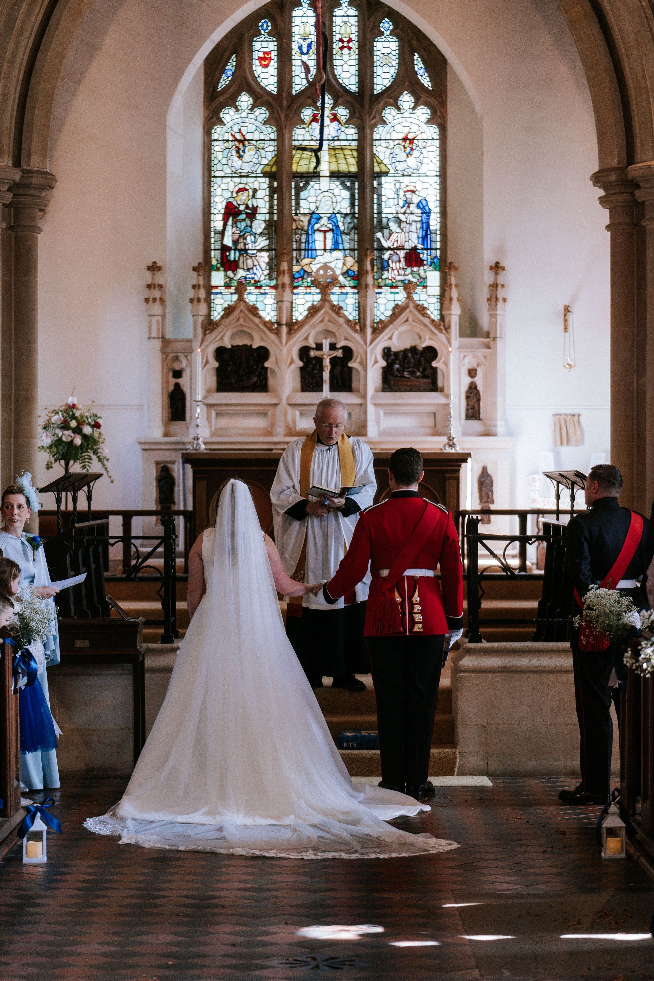 Bride and groom at the altar, seen down the length of the church