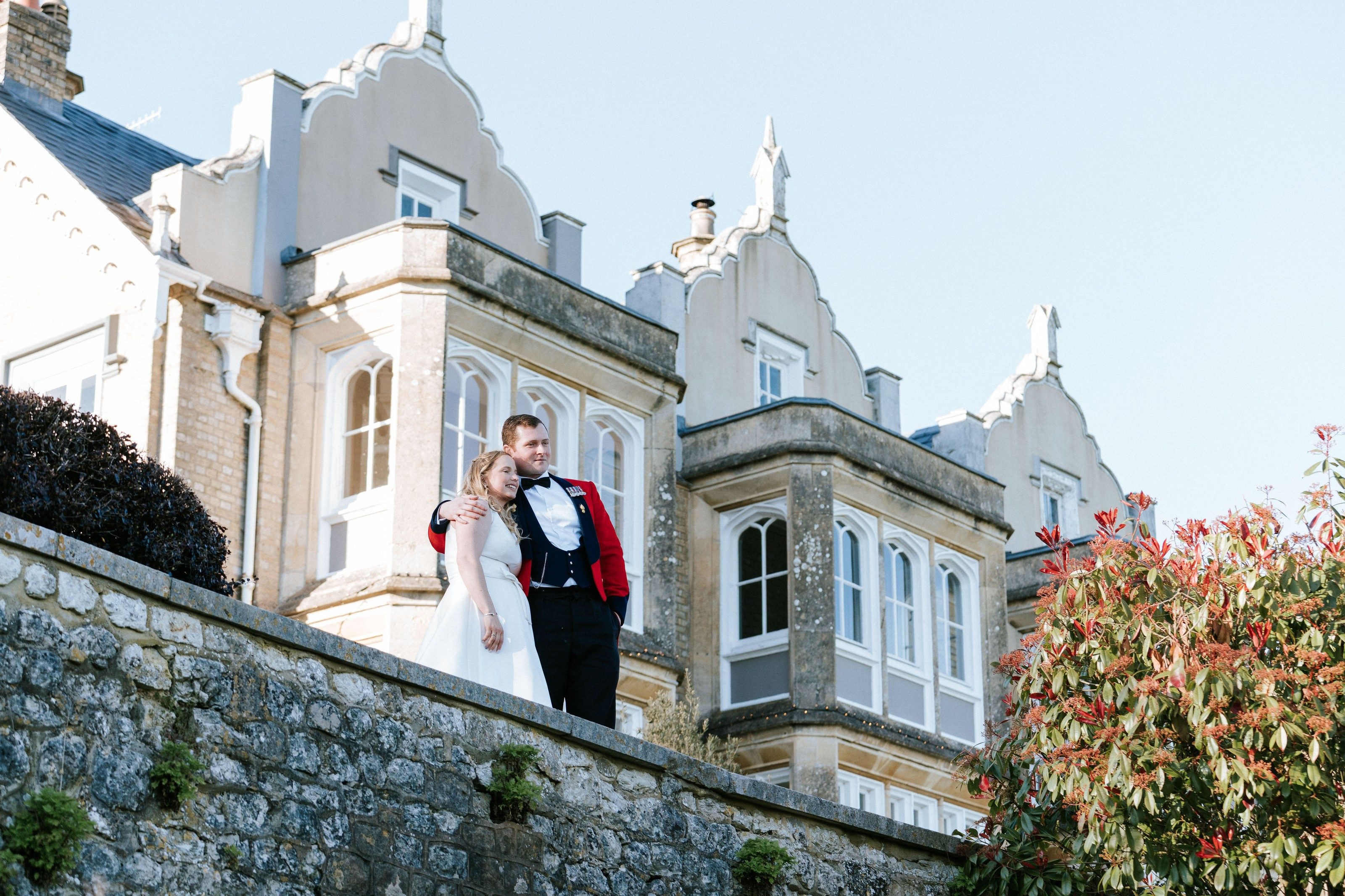 Bride and groom on the terrace of a Victorian country house