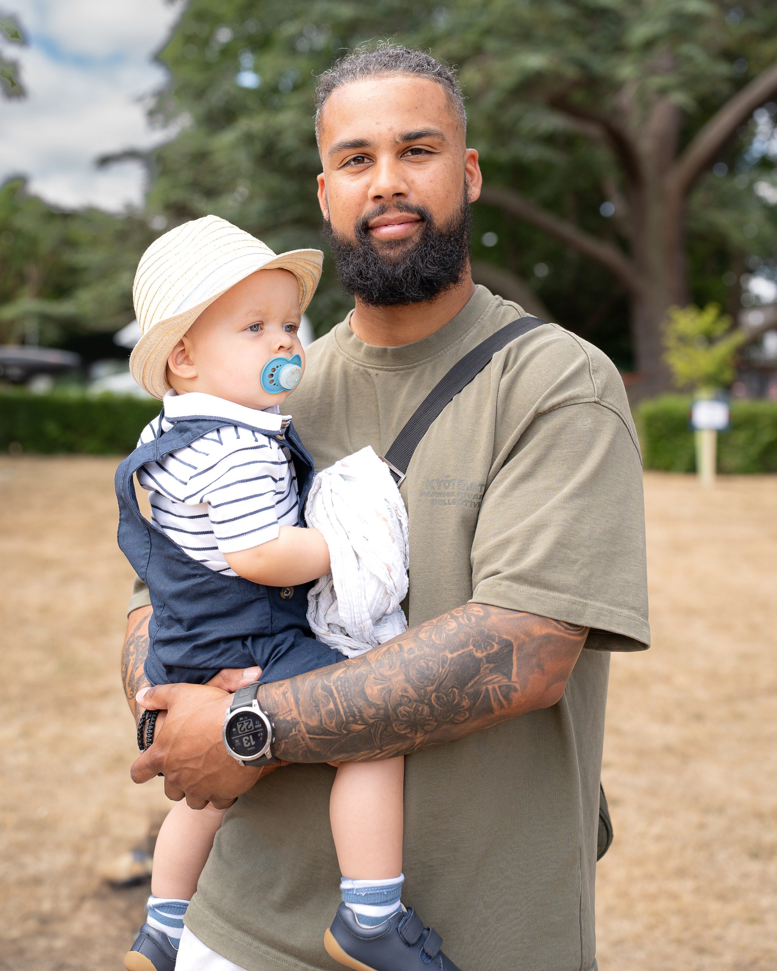 Father holds his young son in the park
