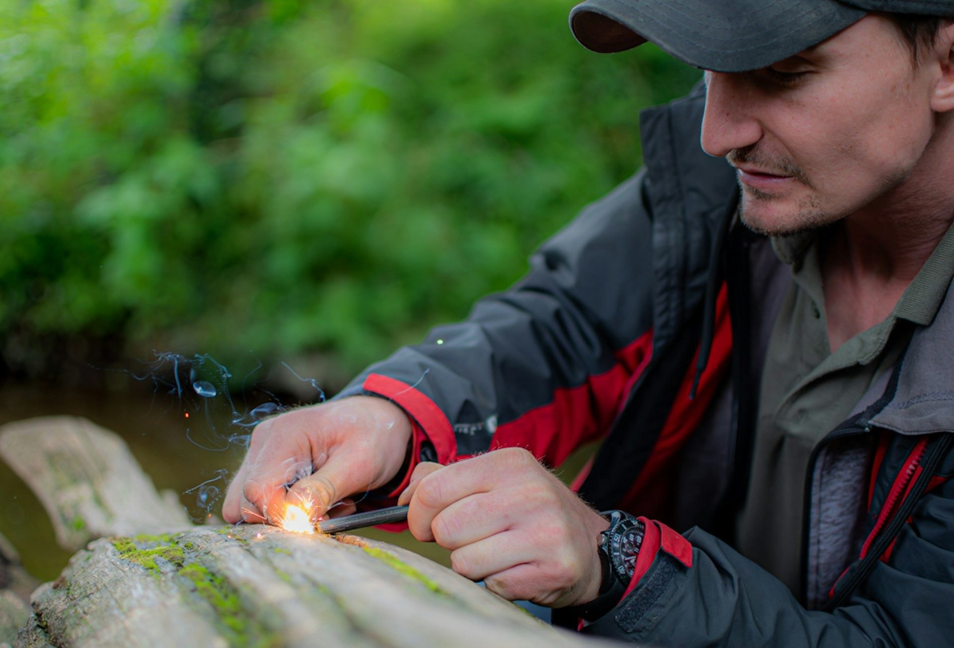 Striking a spark with a ferro rod beside the river