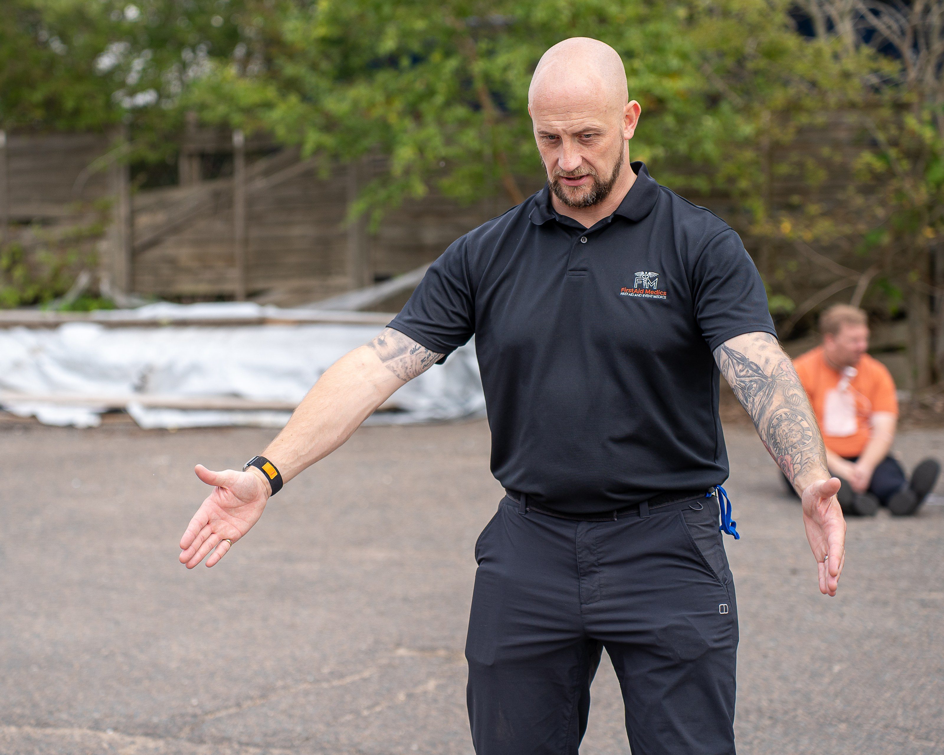 First-aid instructor briefs the group outdoors