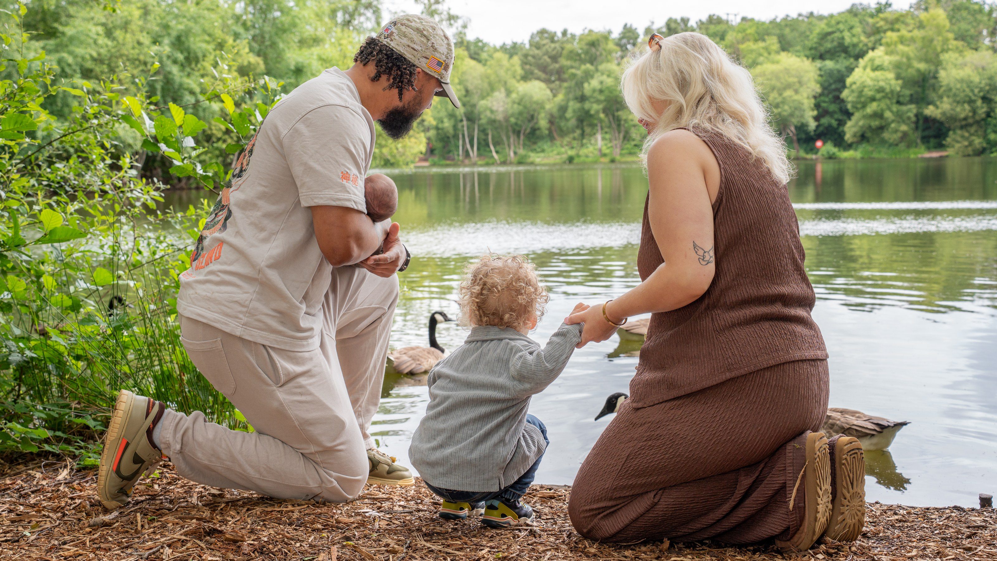 Family together at the edge of the lake