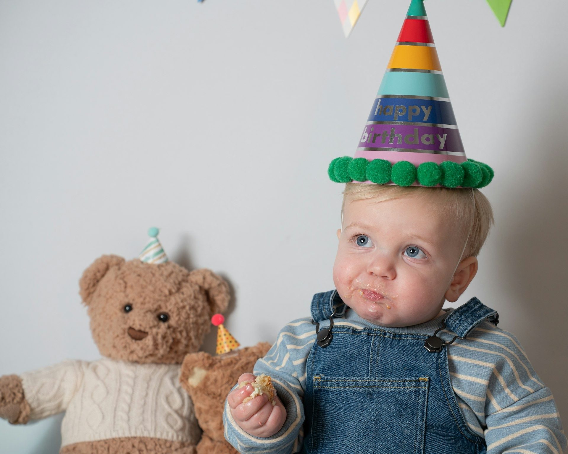 Toddler in a rainbow party hat