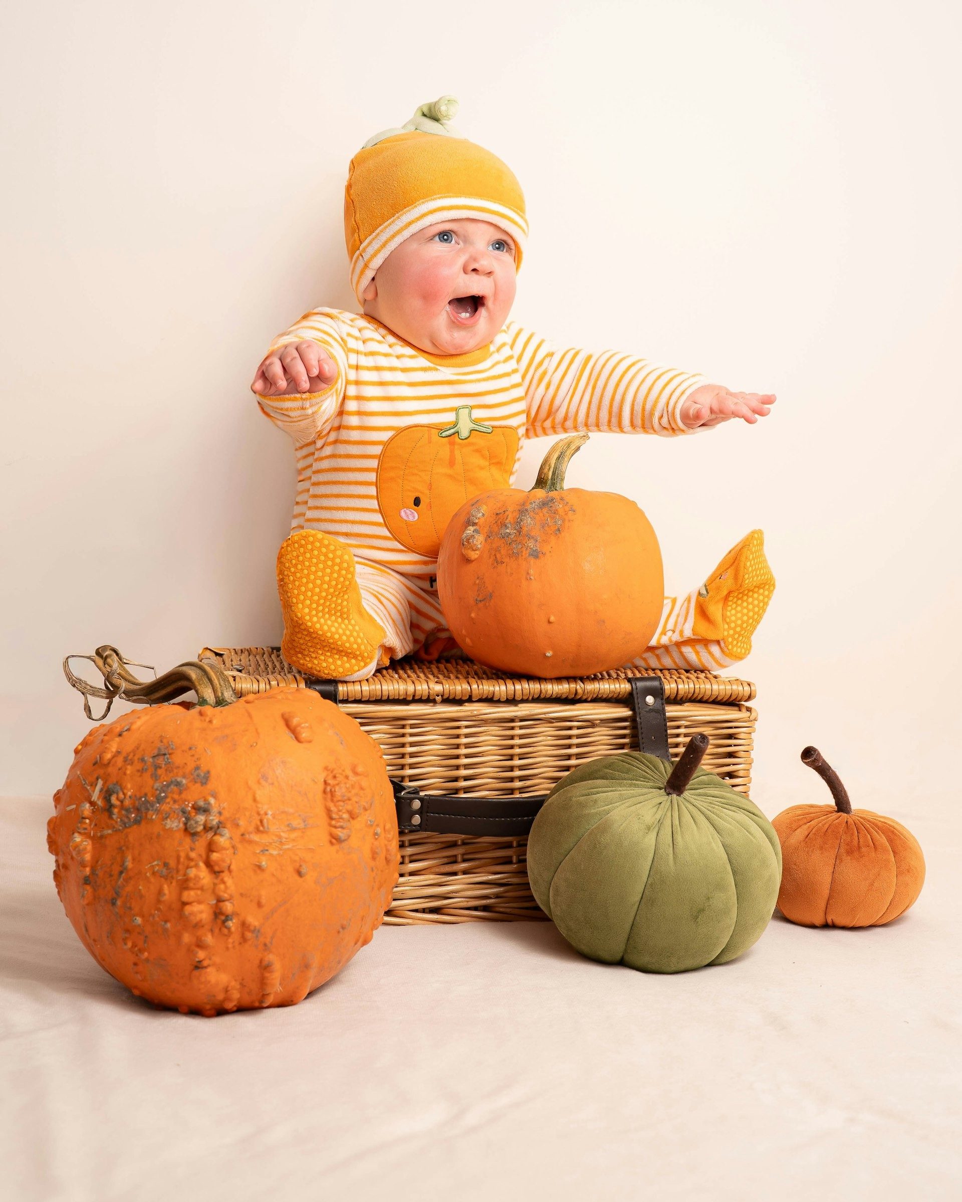 Baby reaching out from a pumpkin patch set