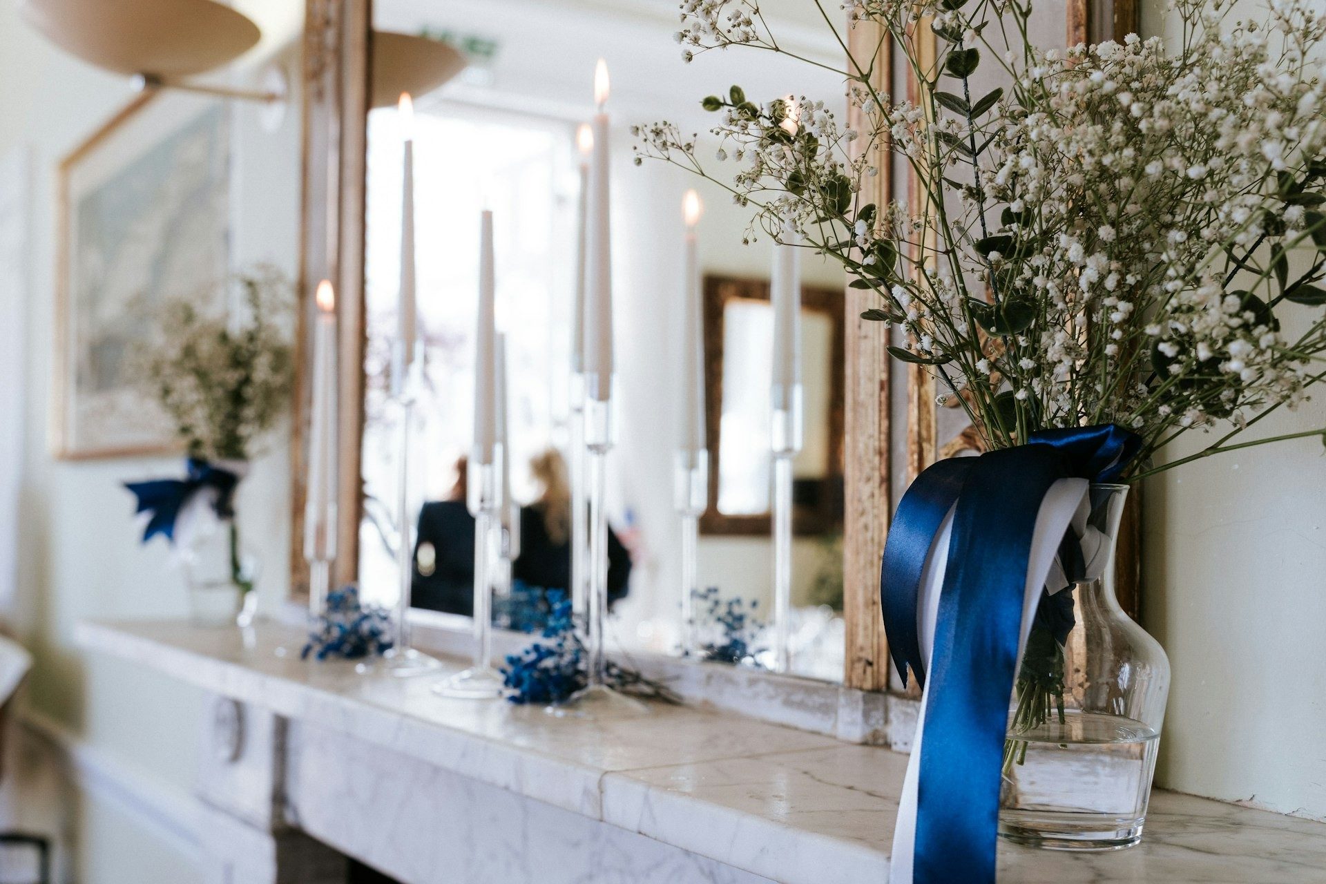 Candles and blue ribbon styled on the reception table