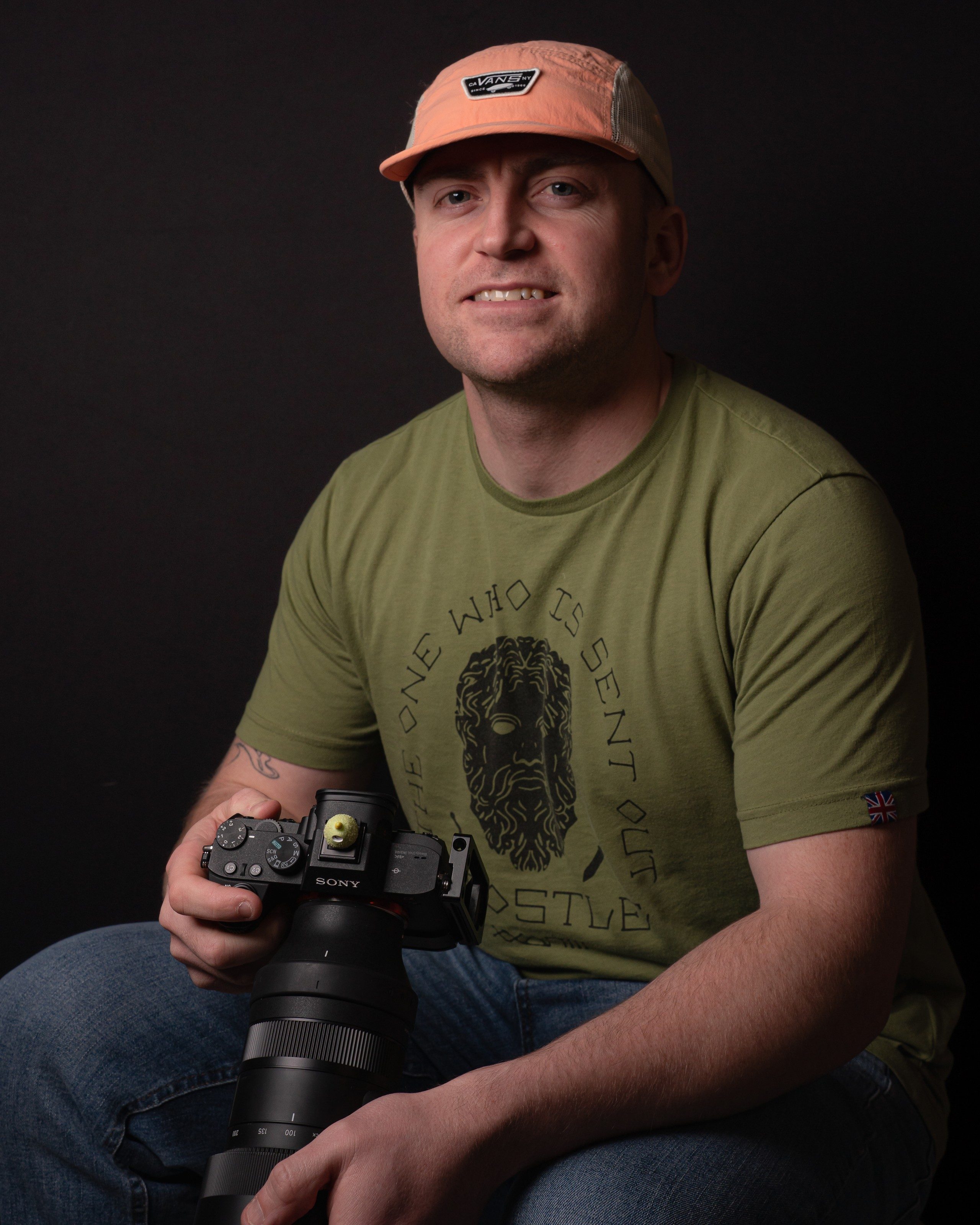 William Farmer holding his Sony camera, photographed in the studio
